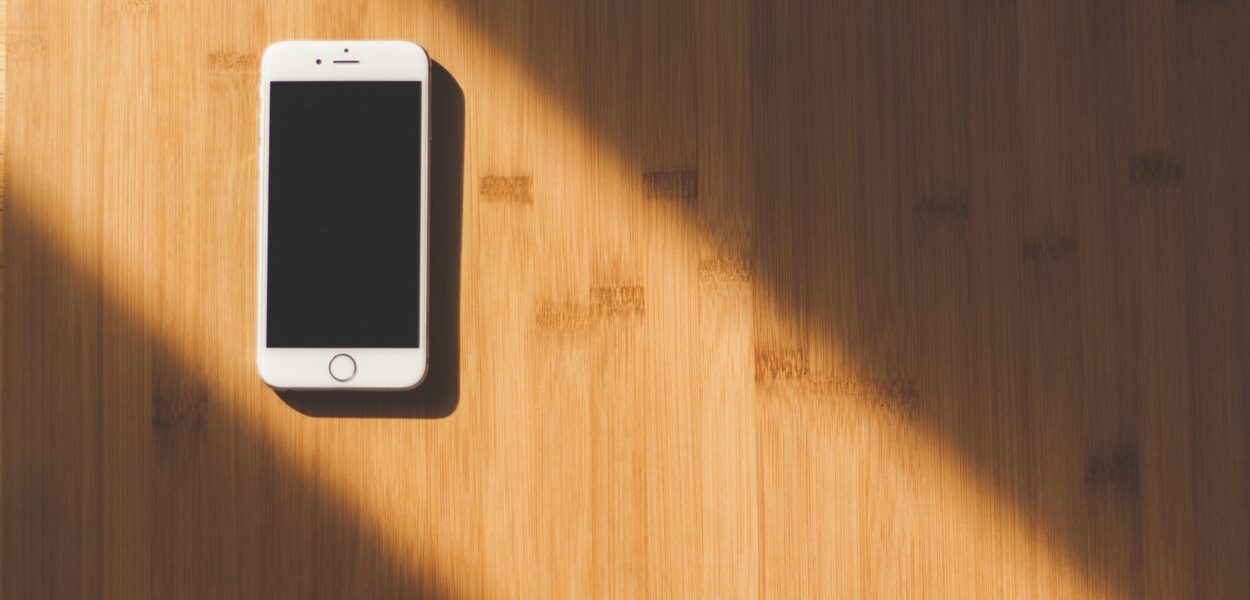 white apple iphone on wooden table